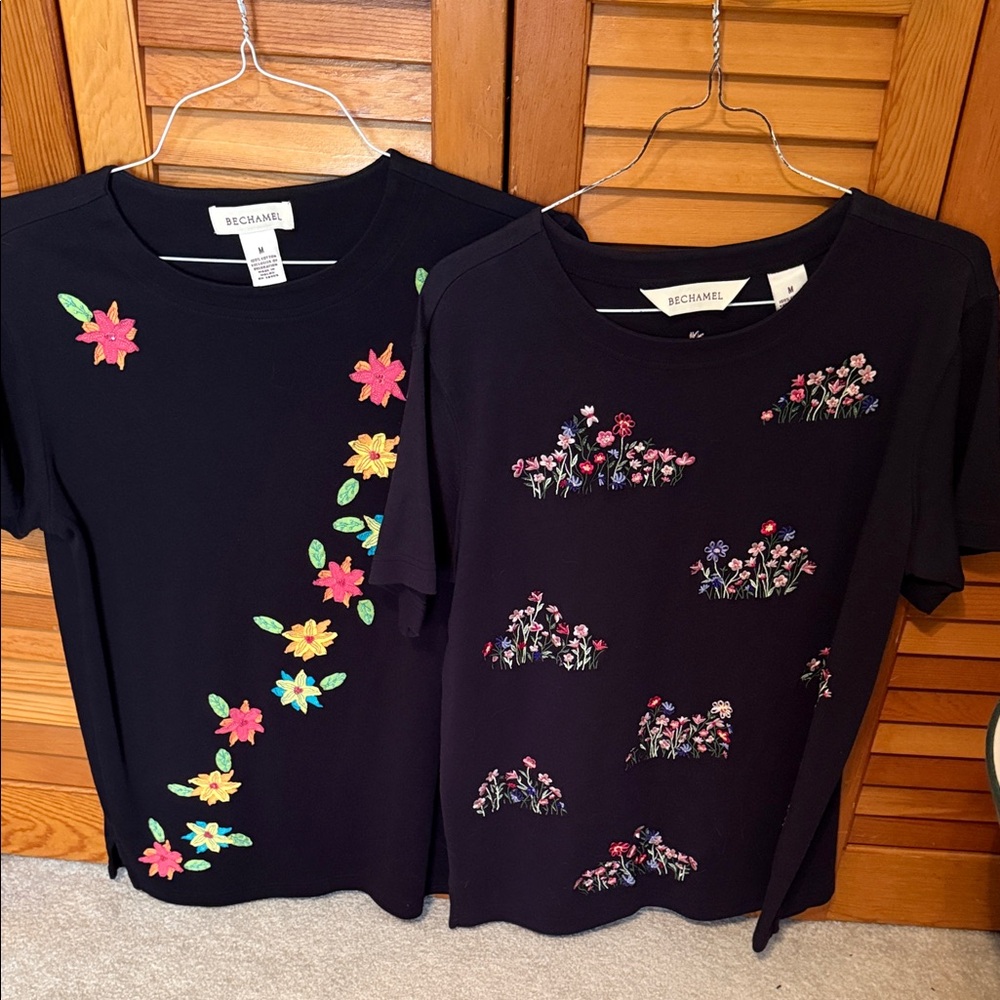 Two Bechamel short sleeve shirts. Black with flower appliqués. Both size M